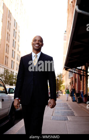 A street portait of a busienss man walking down the sidewalk Stock Photo