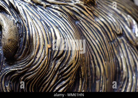 Bronze carving details in closeup macro view with attention to the strikes and curves of bronze and molten lead forming a unique pattern in metal Stock Photo