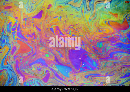 Toxic colours of oil and water in a chemical spill creating a ...