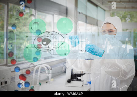 Scientist in protective suit working with green cell diagram interface against dna helix in blue and red with ecg line Stock Photo