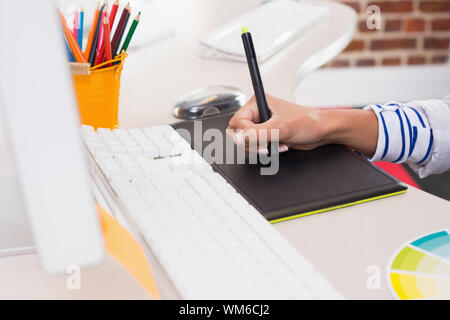 Close up side view of hand using digitizer in the office Stock Photo