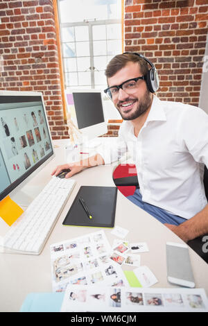 Portrait of smiling male photo editor using computer in the office Stock Photo