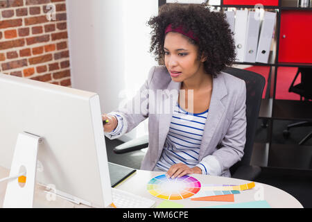 Casual female photo editor using computer in the office Stock Photo