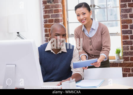 Two business people using digital tablet in the office Stock Photo