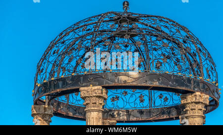 Panorama Cast iron gazebo with dome roof supported by five white stone pillars Stock Photo