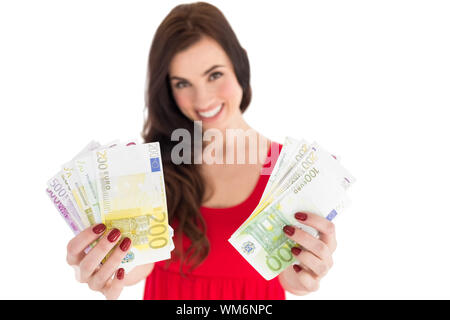 Cheerful brunette showing her cash money Stock Photo - Alamy