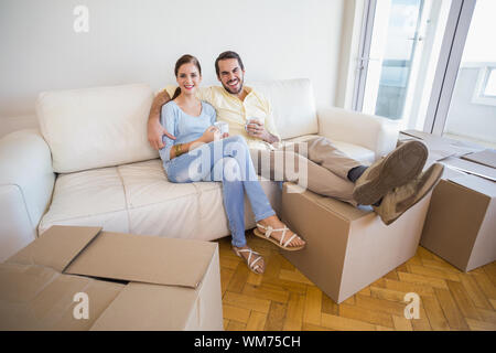 Young couple taking a break from unpacking in their new home Stock Photo