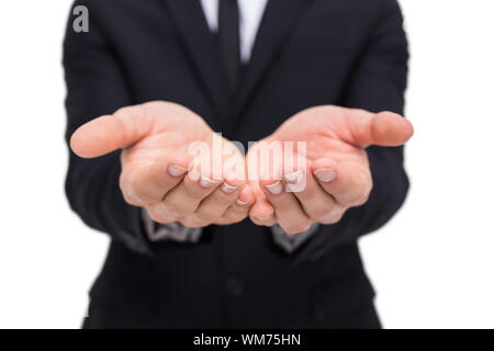 Mid section of a businessman gesturing on white background Stock Photo