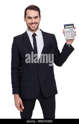 Smiling businessman presenting a calculator on white background Stock Photo
