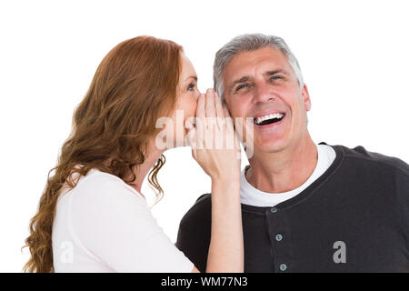 Woman telling secret to her partner on white background Stock Photo