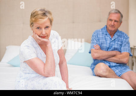 Senior couple not speaking after an argument on bed at home in bedroom Stock Photo