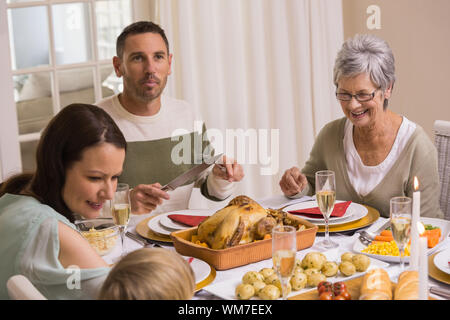 Smiling multi generation during christmas dinner at home in the living room Stock Photo