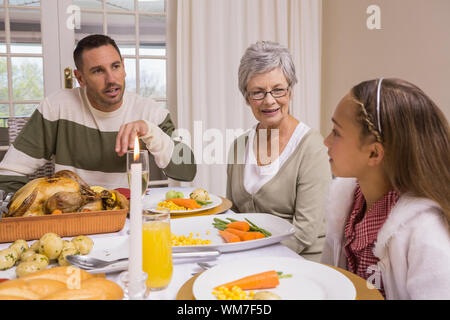 Extended family at the christmas dinner table at home in the living room Stock Photo