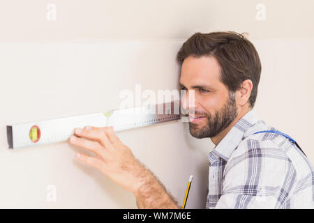 Construction worker using spirit level in a new house Stock Photo