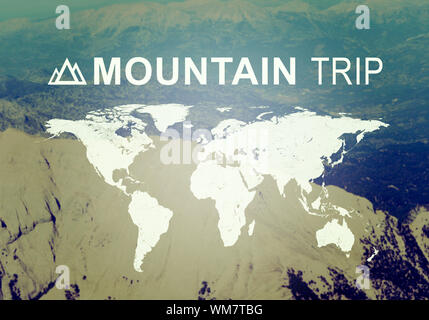 Contoured map of world continents with inscription Mountain Trip. Aerial view of  mountainous desert terrain as backdrop Stock Photo