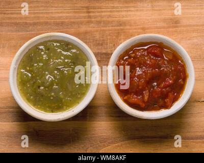 close up of rustic red tomato salsa and green salsa verde Stock Photo