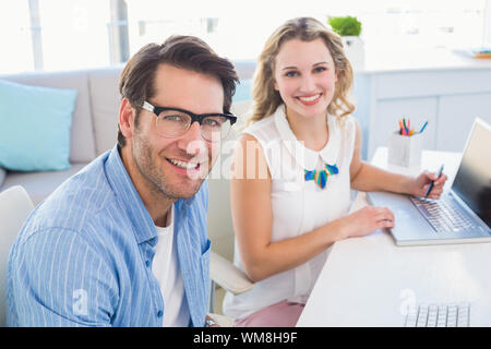 Portrait of two smiling creative business in office Stock Photo