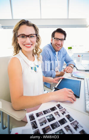 Photo editors working together on graphics tablet in office Stock Photo