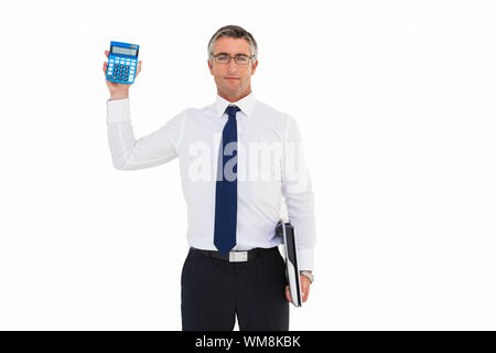 Businessman showing calculator while holding his laptop on white background Stock Photo