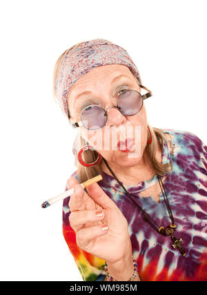 Senior Hippie Lady with Cigarette and Blowing Smoke Rings Stock Photo