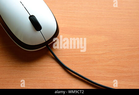 White Wired Computer Mouse on the Wooden Table Stock Photo