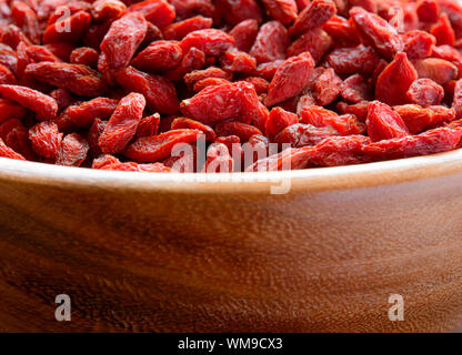 Wooden Bowl Full of Dried Goji Berries. Healthy Diet Stock Photo