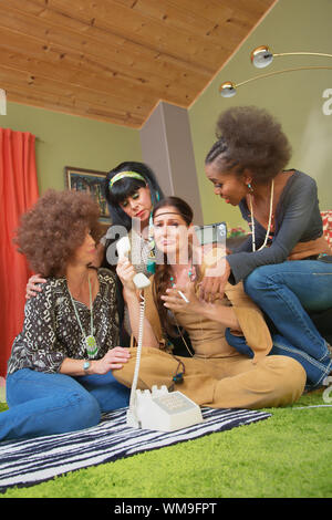 Group of four 1960s middle aged women crying on phone Stock Photo