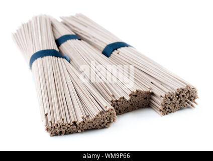 Bundles of buckwheat soba noodles. Isolated on white. Stock Photo