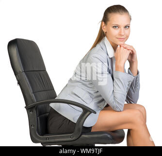 Businesswoman on office chair, with her head reclined upon her hands. Isolated over white background Stock Photo