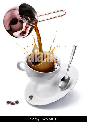 Coffee preparation. Conceptual photo - pouring coffee from copper pot into a cup. Stock Photo