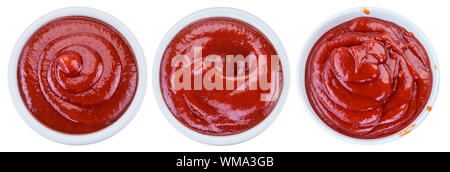 Three bowls of tomato sauce or ketchup on white background. Top view. File contains clipping path for each item. Stock Photo