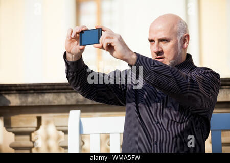 Man taking a photograph with his mobile Stock Photo