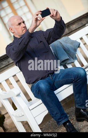 Man taking a photograph with his mobile Stock Photo
