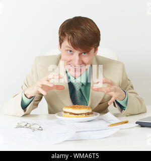 The happy person is going to eat on a workplace Stock Photo