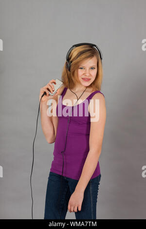 dancing happy teenager girl listening to music Stock Photo
