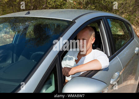 Excited driver holding the keys of his new car Stock Photo