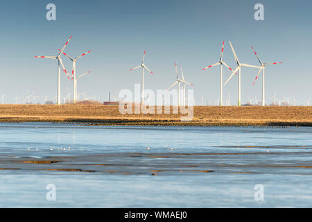 Windmills in northern Germany on a field on a sunny day