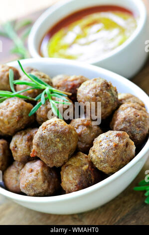 Fresh hot meatball appetizers served in white bowl with dipping sauce Stock Photo