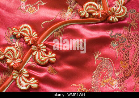 Traditional Chinese Red knot buttons on silk dress with beautiful patterns Stock Photo