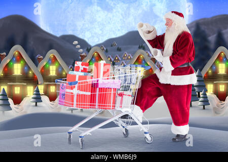 Santa delivering gifts from cart against quaint town with bright moon Stock Photo