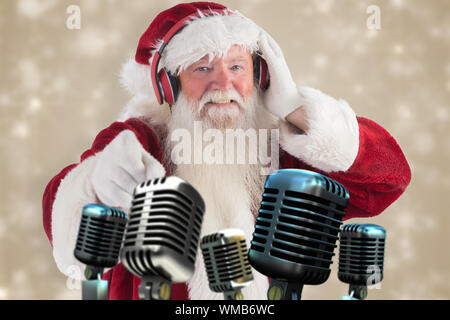 Santa is listening some music against white snowflake design on cream Stock Photo