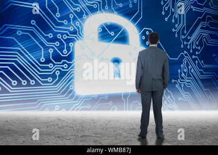 Businessman standing against security graphic in desert setting Stock Photo