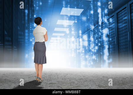 Businesswoman standing against matrix falling in data center Stock Photo