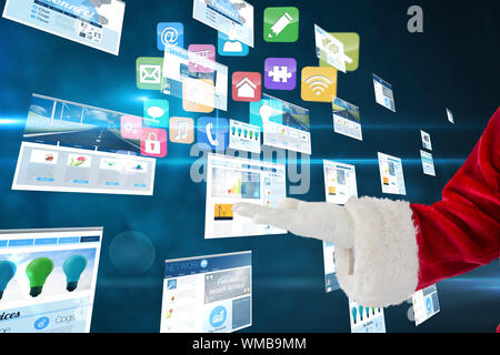 Santa claus presenting with hand against screens showing business advertisement on blue Stock Photo