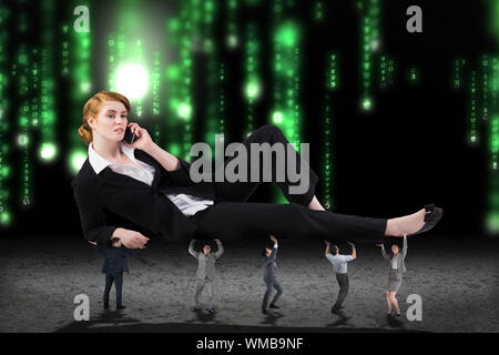 Business people supporting boss against green glowing matrix Stock Photo