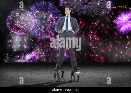 Business people supporting boss against purple firework display Stock Photo