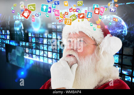 Santa is thinking about something against wall of digital screens in blue Stock Photo