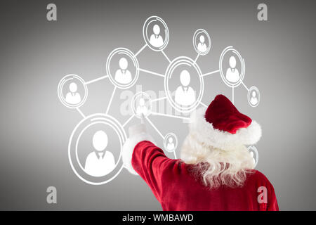 Composite image of santa claus points at something against grey vignette Stock Photo