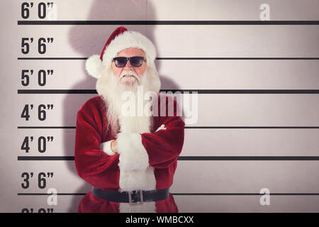 Santa Claus wears black sunglasses  against mug shot background Stock Photo