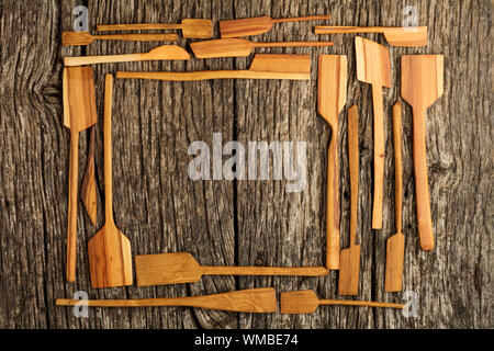 Rural kitchen utensils on vintage planked wood table from above - rustic background with free text space. Flat lay. Stock Photo